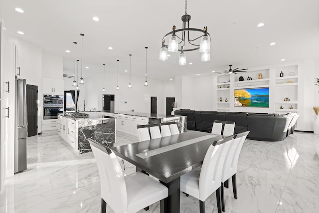 6316 La Paz Rd NE, Rio Rancho, NM 87144 - dining area with a chandelier, light marble finish flooring, recessed lighting, built in features, and a ceiling fan