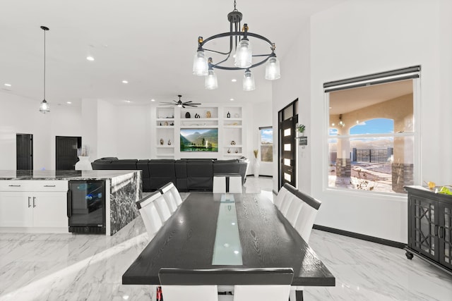 6316 La Paz Rd NE, Rio Rancho, NM 87144 - dining space with beverage cooler, a chandelier, ceiling fan, recessed lighting, and light marble finish flooring