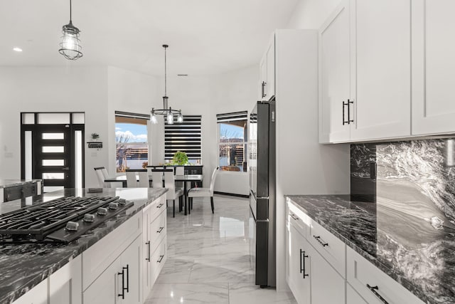 6316 La Paz Rd NE, Rio Rancho, NM 87144 - kitchen featuring gas cooktop, plenty of natural light, light marble finish floors, dark stone counters, and recessed lighting