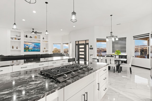 6316 La Paz Rd NE, Rio Rancho, NM 87144 - kitchen with stainless steel gas cooktop, open floor plan, white cabinetry, recessed lighting, and a ceiling fan