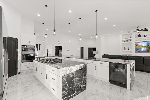 6316 La Paz Rd NE, Rio Rancho, NM 87144 - kitchen with beverage cooler, stainless steel appliances, a spacious island, open floor plan, and recessed lighting