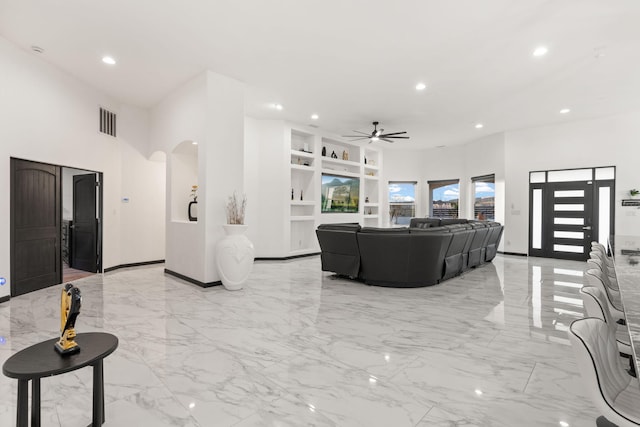 6316 La Paz Rd NE, Rio Rancho, NM 87144 - living area with built in features, light marble finish floors, ceiling fan, recessed lighting, and arched walkways