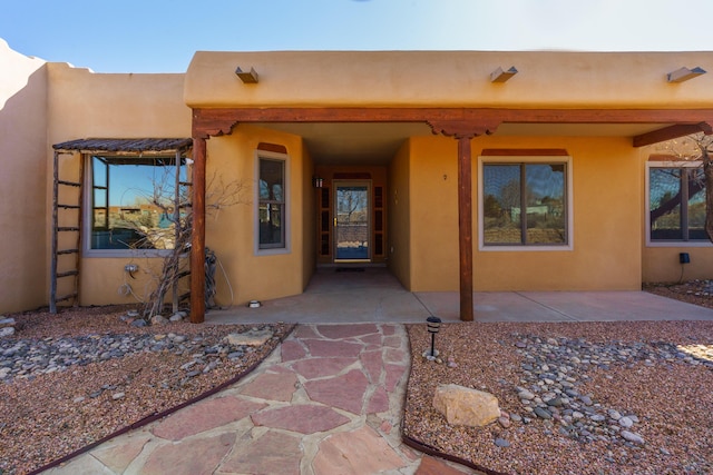 doorway to property with a patio