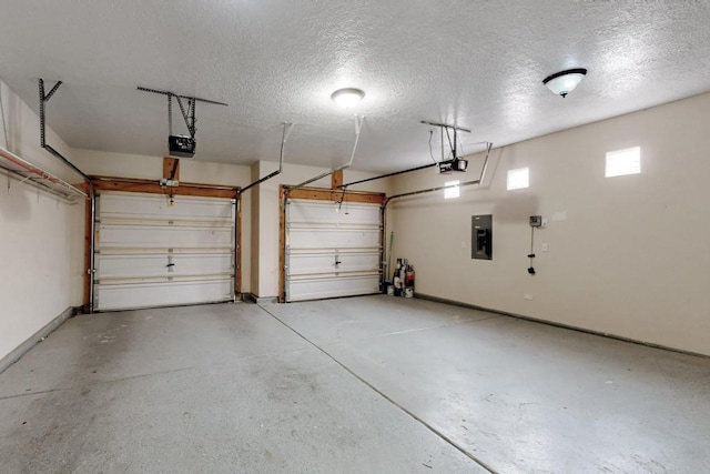 garage with electric panel and a garage door opener