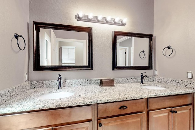 full bath featuring double vanity and a sink