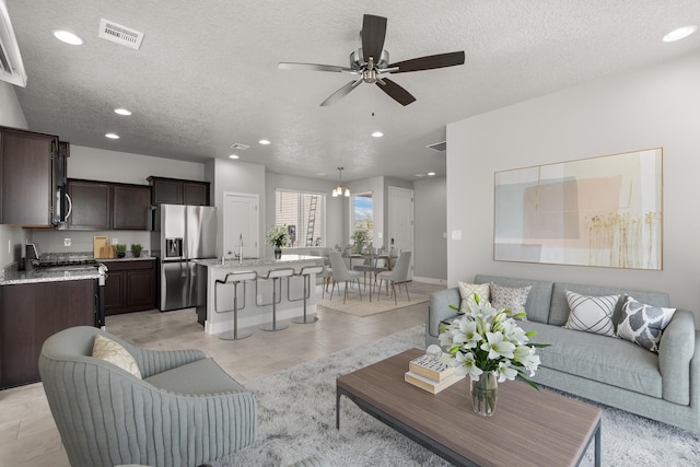 392 Pecos Loop SE, Rio Rancho, NM 87124 - living room with recessed lighting, a textured ceiling, ceiling fan, and light tile patterned floors