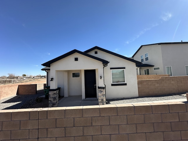 392 Pecos Loop SE, Rio Rancho, NM 87124 - view of front of home featuring fence and stucco siding