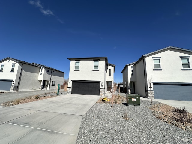 392 Pecos Loop SE, Rio Rancho, NM 87124 - contemporary house featuring a garage, stucco siding, concrete driveway, and stone siding