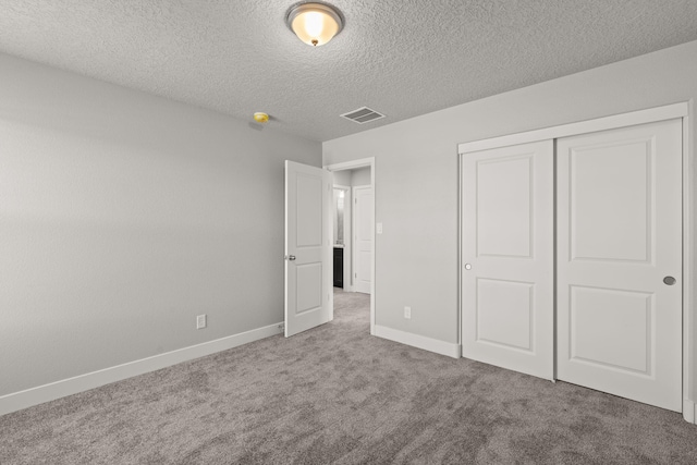 392 Pecos Loop SE, Rio Rancho, NM 87124 - unfurnished bedroom featuring carpet, baseboards, a textured ceiling, and a closet