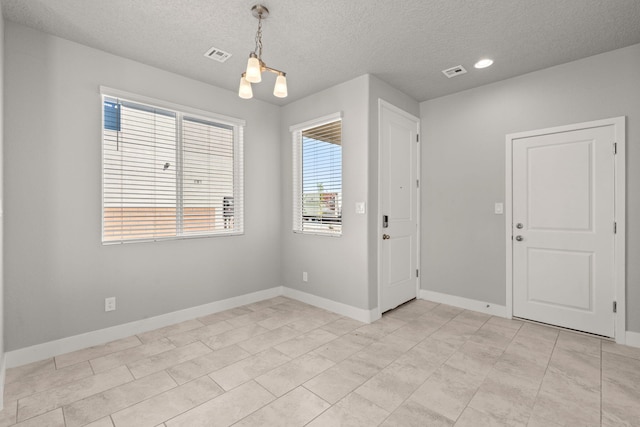 392 Pecos Loop SE, Rio Rancho, NM 87124 - spare room with a textured ceiling, baseboards, a chandelier, and recessed lighting