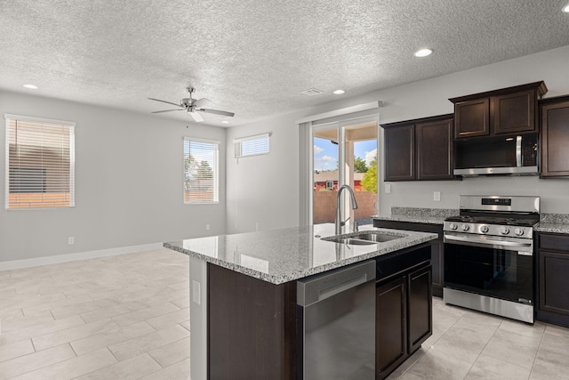392 Pecos Loop SE, Rio Rancho, NM 87124 - kitchen with stainless steel appliances, a sink, a ceiling fan, a kitchen island with sink, and a textured ceiling