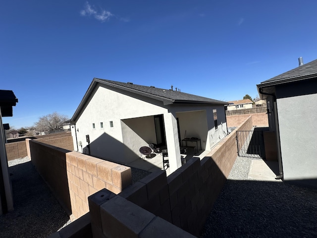 392 Pecos Loop SE, Rio Rancho, NM 87124 - view of property exterior featuring stucco siding and fence