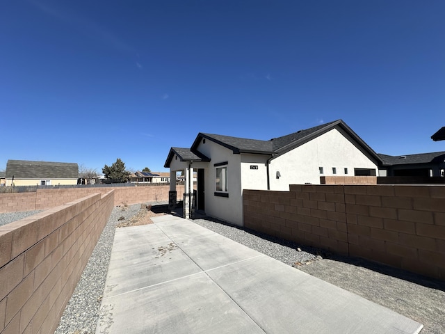 392 Pecos Loop SE, Rio Rancho, NM 87124 - view of side of property with stucco siding, a fenced backyard, and a patio
