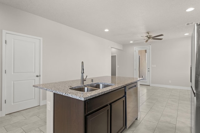 392 Pecos Loop SE, Rio Rancho, NM 87124 - kitchen with a sink, appliances with stainless steel finishes, dark brown cabinets, ceiling fan, and an island with sink