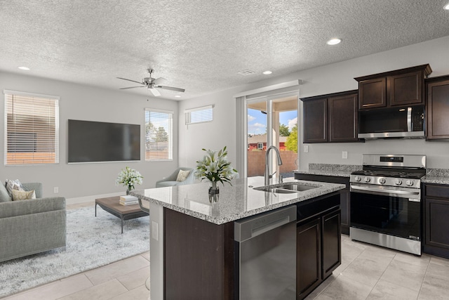 392 Pecos Loop SE, Rio Rancho, NM 87124 - kitchen with stainless steel appliances, a sink, open floor plan, ceiling fan, and light stone counters