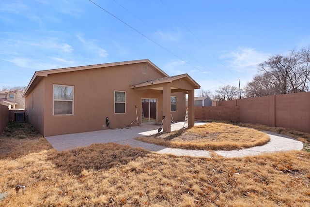1735 Garden Way SW, Albuquerque, NM 87105 - back of property featuring a patio area, a fenced backyard, central AC, and stucco siding