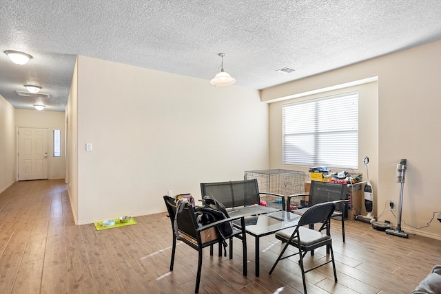 1735 Garden Way SW, Albuquerque, NM 87105 - dining room featuring a healthy amount of sunlight, light wood-style flooring, visible vents, and a textured ceiling