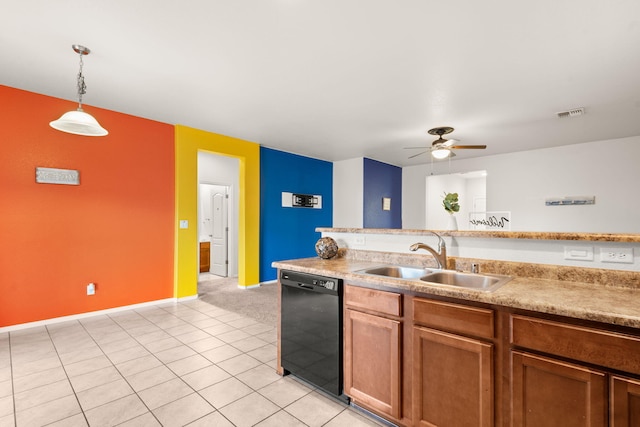 kitchen with black dishwasher, brown cabinetry, decorative light fixtures, light countertops, and a sink