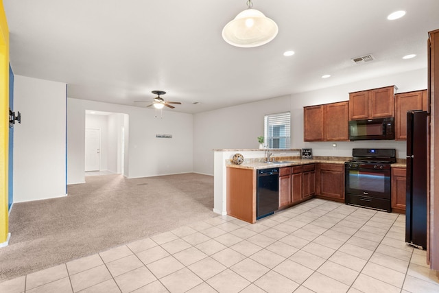 kitchen with visible vents, brown cabinetry, light colored carpet, open floor plan, and black appliances