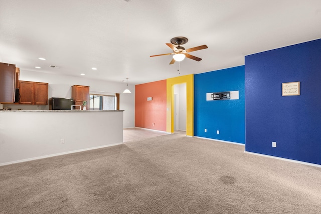 unfurnished living room with recessed lighting, baseboards, a ceiling fan, and light colored carpet