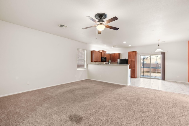 unfurnished living room featuring light carpet, baseboards, visible vents, a ceiling fan, and recessed lighting