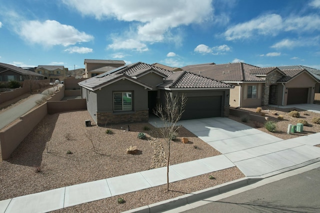 view of front of home with a garage, driveway, a tiled roof, and stucco siding