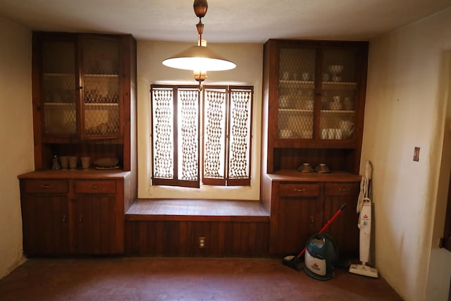 dining area with wooden walls and dark colored carpet