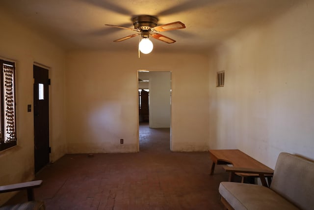 interior space with visible vents and ceiling fan