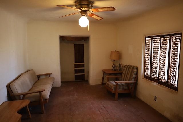 living area with dark wood finished floors and ceiling fan