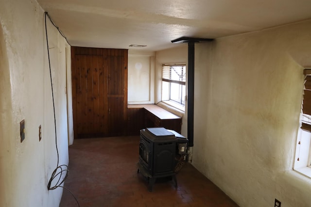 interior space with a wood stove and visible vents