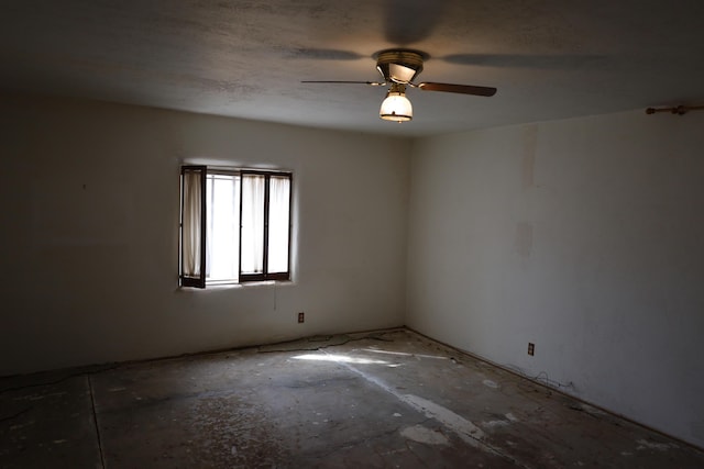 empty room with a textured ceiling and a ceiling fan