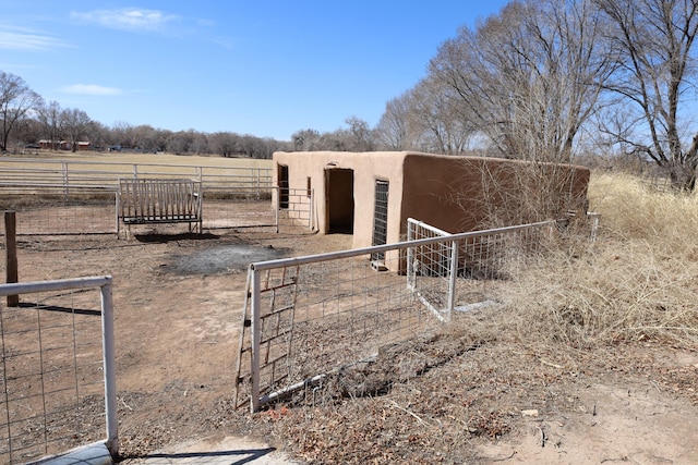 exterior space with an exterior structure, a rural view, and an outdoor structure