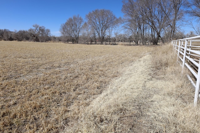 view of yard featuring a rural view and fence