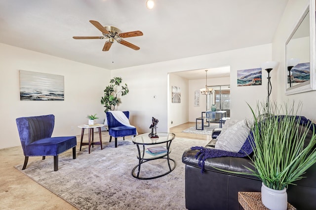 living area with ceiling fan with notable chandelier and carpet flooring