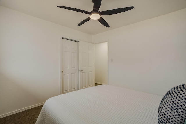 bedroom featuring baseboards, dark colored carpet, and a ceiling fan