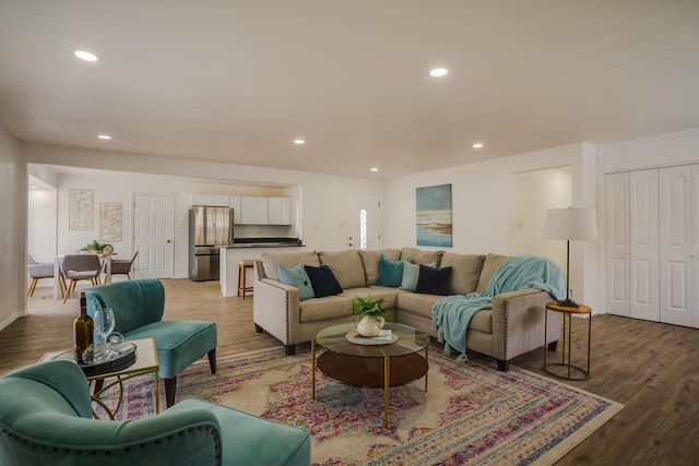 living area featuring light wood finished floors and recessed lighting