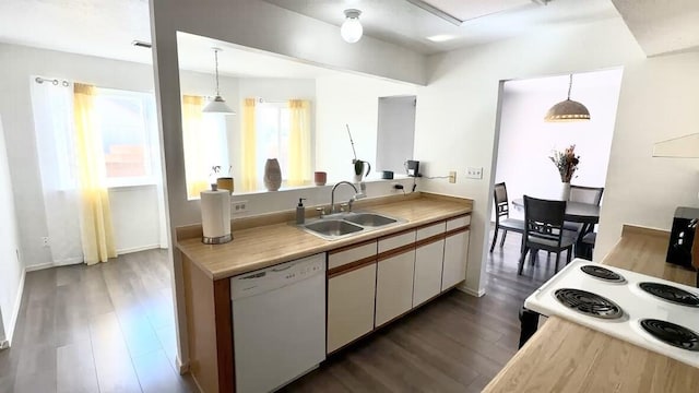 kitchen with white cabinets, dishwasher, decorative light fixtures, light countertops, and a sink