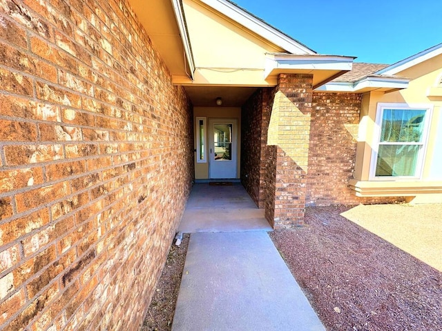 entrance to property featuring brick siding