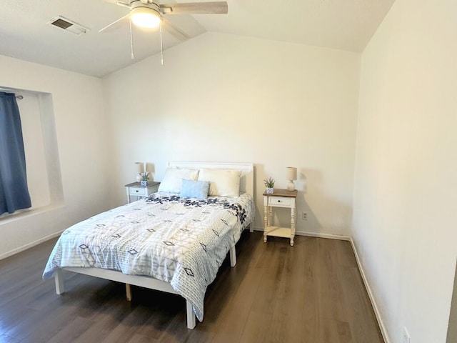 bedroom featuring lofted ceiling, dark wood-type flooring, a ceiling fan, visible vents, and baseboards