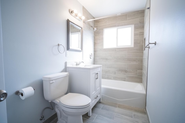 bathroom featuring bathtub / shower combination, vanity, and toilet