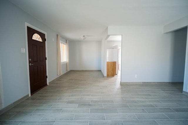 foyer entrance featuring baseboards