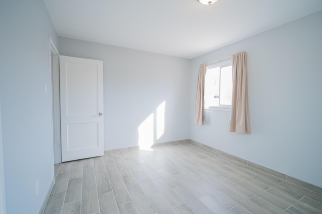 empty room featuring wood tiled floor