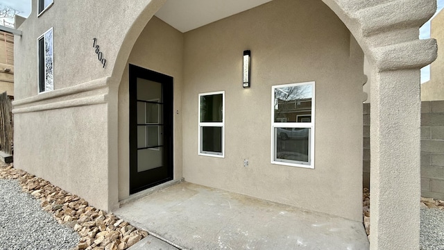 property entrance with stucco siding