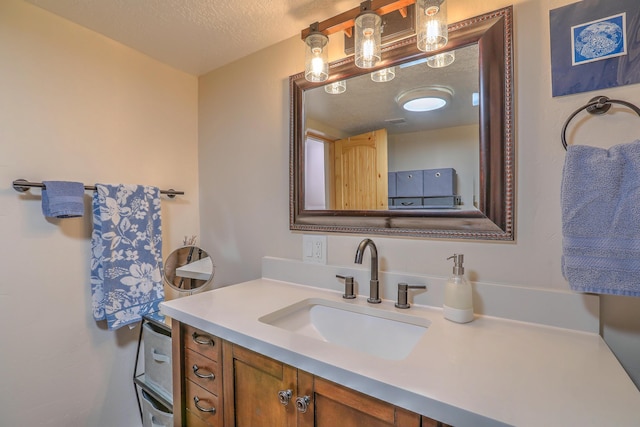 bathroom featuring a textured ceiling and vanity