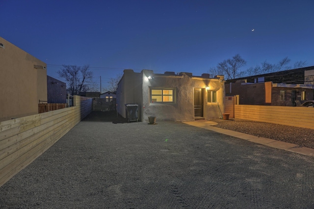 view of front facade with fence private yard and stucco siding