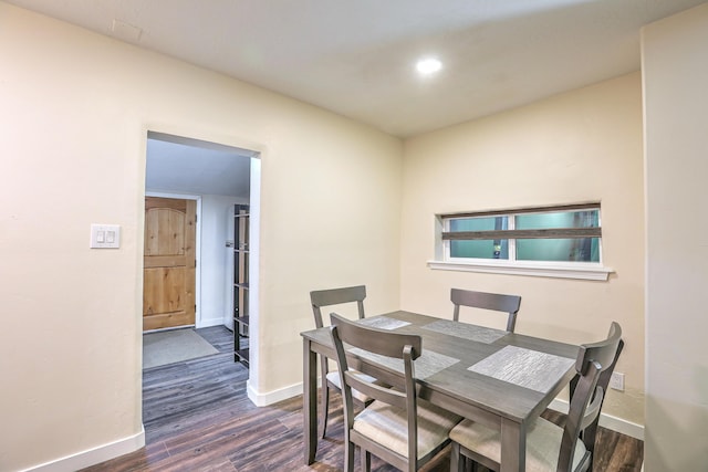 dining area with baseboards and dark wood-style flooring