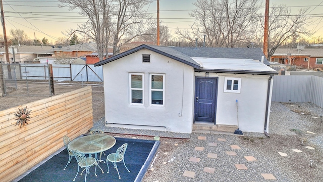 view of outbuilding with a fenced backyard and an outbuilding