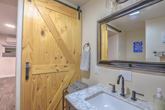 bathroom with vanity and a wall mounted AC