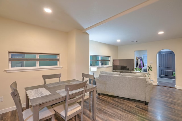 dining space with baseboards, arched walkways, dark wood finished floors, and recessed lighting