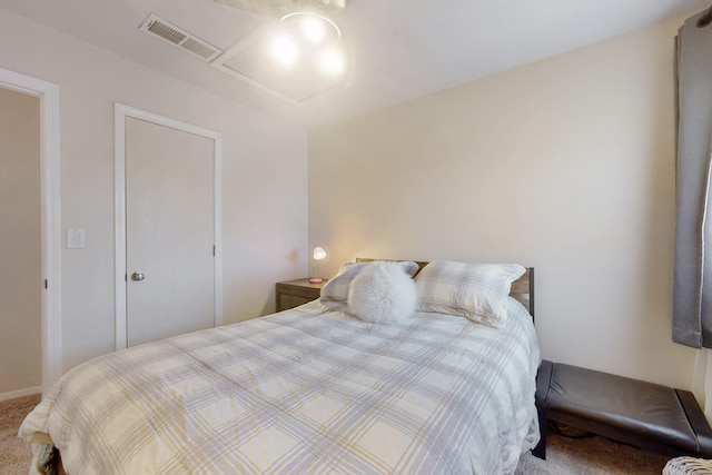 carpeted bedroom featuring attic access and visible vents